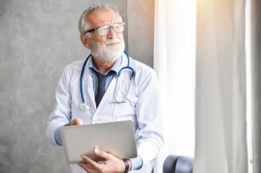 nephrologist looking at test results on a laptop